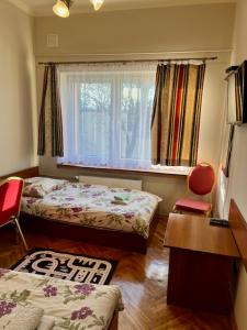a small room with two beds and a window at Kwatery w centrum Stary Rynek 4 a in Łowicz +22 photos