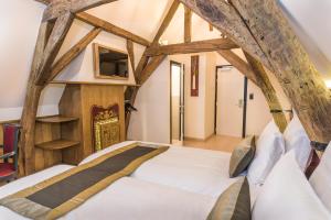 a bed in a room with wooden beams at Hotel Agora Brussels Grand Place in Brussels