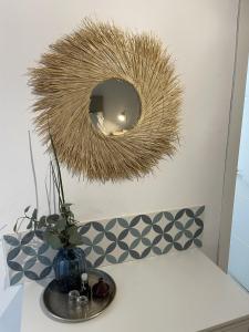 a mirror on top of a table with a vase at Olive & Ivy Guest House in Canillas de Aceituno +68 photos