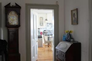 a door leading to a kitchen with a clock at Lynwood house in Cobh