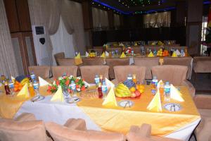 a table with food and fruit on it in a hall at Diana Palace Hotel in Diyānah +36 photos