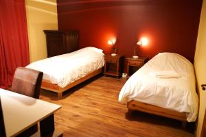 two beds in a room with two tables and two lamps at Gite MontBlanc in Verrens-Arvey