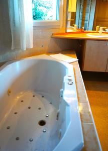 a large bath tub in a bathroom with a window at Gite MontBlanc in Verrens-Arvey +20 photos