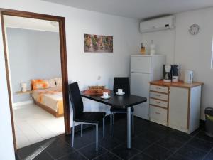 a room with a table and a bedroom with a bed at Feriendomizil Moll in Bilice