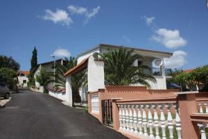 a house with a fence on the side of a street at Feriendomizil Moll in Bilice