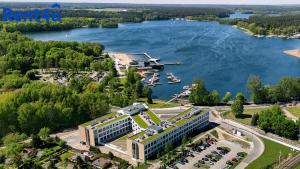 an aerial view of a building next to a lake at Nad Zatoką Aparthotel by Rent4You in Olsztyn