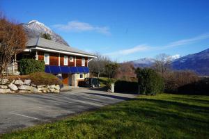 a house on a street with mountains in the background at Gite MontBlanc in Verrens-Arvey