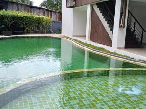 a pool of water in front of a building at Private apartment at Kris Condo by Lofty in Surin Beach