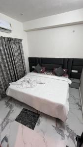 a bed in a room with a marble floor at Millennium Suites - Comfy Rooms in Orchha