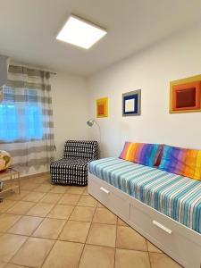 a bedroom with a bed and a chair at Casa Bauhaus - Design E Comfort A 400 M Dalla Spiaggia Di Pescoluse in Marina di Pescoluse