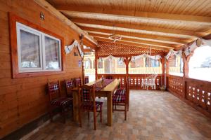a dining room with a wooden table and chairs at Casa Alina Breb in Breb