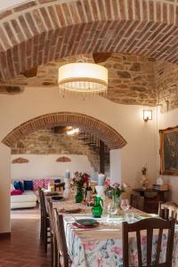 a dining room with a long table with chairs at Villa Lux Poggelleri vista unica sul Casentino in Poppi