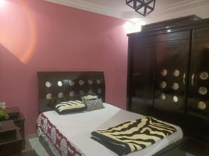 a bedroom with a bed with zebra pillows on it at شقة إكسترا لوكس على النيل in Cairo
