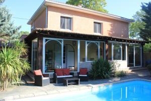 a house with a pool in front of it at Ty Calon Lan in Montazels