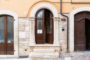 a building with two wooden doors on the side at B&B La Casa Di Tocco in Tocco da Casauria