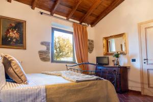 a bedroom with a bed and a window at Villa Lux Poggelleri vista unica sul Casentino in Poppi +121 photos