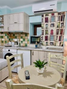 a kitchen with a table and chairs and a sink at Green House Skiathos in Skiathos +72 photos