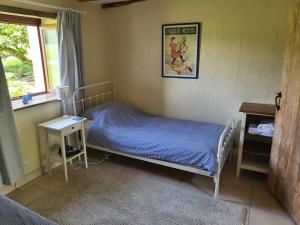 a small bedroom with a bed and a window at Gites at Le Tilleul - Le Pommier in Le Lindois +19 photos