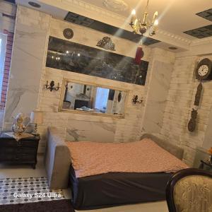 a bedroom with a bed and a clock on the wall at Apartament Wilhelma II in Ząbkowice Śląskie
