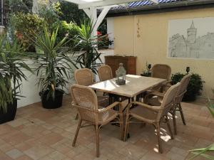 a wooden table and chairs on a patio at Ferienwohnung Stargard in Burg Stargard