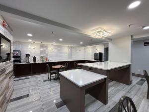 a kitchen with tables and chairs in a room at Motel 6 Prattville AL in Prattville