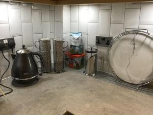 a kitchen counter with a mixer and other appliances at Cherry Tree Villa in Harrogate