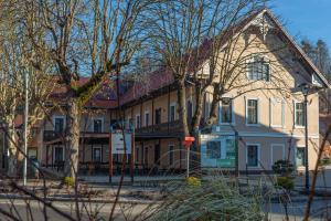 a building on the corner of a street with trees at Gostišče Pod Kostanji in Dobrna