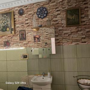 a bathroom with a sink and a stone wall at Apartament Wilhelma II in Ząbkowice Śląskie +64 photos