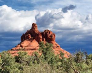 a red rock mountain with trees in front of it at La Casa De Camilla in Sedona