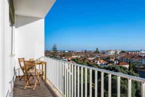 a balcony with a table and chairs and a view at Sunset Horizon Carcavelos in Carcavelos +37 photos