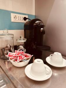a counter with plates and bowls on a counter top at Mocenigo Vatican Suites in Rome +57 photos