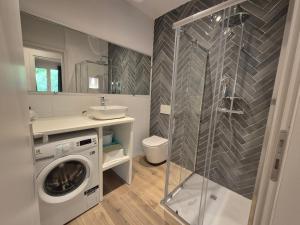 a bathroom with a washing machine and a sink at Park Residence Il Gabbiano in Moniga +74 photos