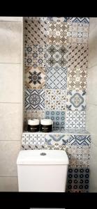 a bathroom with blue and white tiles on the wall at Ioannina Center Apartment in Ioannina