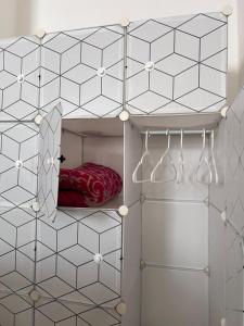 a bedroom with a bed in a room with white tiled walls at Casa Múkara del Puerto in Veracruz