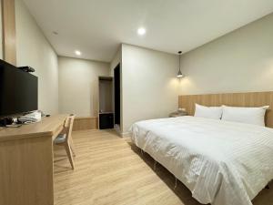 Ένα ή περισσότερα κρεβάτια σε δωμάτιο στο Yoshi Hotel - Tainan Sinmei Branch
