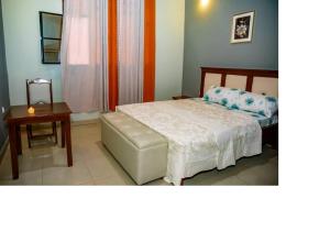 Postel nebo postele na pokoji v ubytování Bujumbura Hotel and Appartment