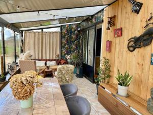 a living room with a table and a couch at Grande maison à 200m de la plage in Plouguerneau