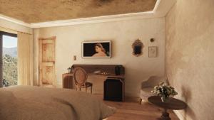 a bedroom with a bed and a desk and a chair at Domaine Santa Margherita in Castellare-di-Casinca