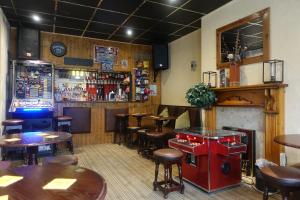 a restaurant with tables and chairs and a bar at The Kings Cross Hotel in Blackpool