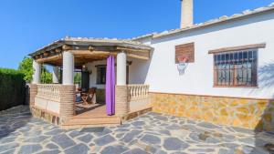 a house with a gazebo on a patio at Cortijo El Olivar Órgiva by Ruralidays in Órgiva