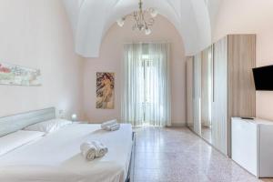 Postel nebo postele na pokoji v ubytování Palazzo Rondine - Affittacamere con cucina