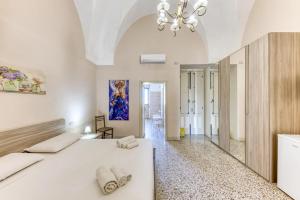 Postel nebo postele na pokoji v ubytování Palazzo Rondine - Affittacamere con cucina