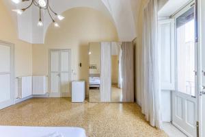 Postel nebo postele na pokoji v ubytování Palazzo Rondine - Affittacamere con cucina