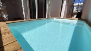 a large blue swimming pool on top of a wooden floor at Cas Bunyoler in Cala Ratjada