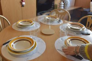 a table with plates and glasses on top of it at Bardoney Ski Lodge in Breuil-Cervinia +5 photos