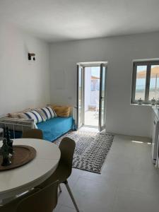 a living room with a couch and a table at Comfortable apartment with sea view in Antiparos, 77 m² in Andiparos