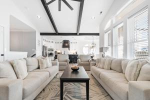 a living room with a large couch and a table at The Grand View 5bedrooms 5 Ba, Elevator, Heated Pool in Ocean Isle Beach