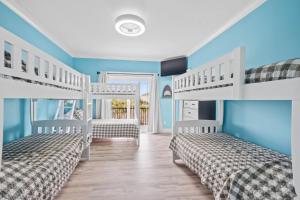 two bunk beds in a room with blue walls at The Grand View 5bedrooms 5 Ba, Elevator, Heated Pool in Ocean Isle Beach +62 photos