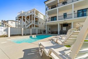 a patio with lounge chairs and a swimming pool at The Grand View 5bedrooms 5 Ba, Elevator, Heated Pool in Ocean Isle Beach