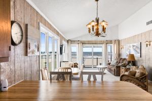 a dining room and living room with a dining table at Ocean Front, Pet Friendly with AMAZING Views in Ocean Isle Beach in Ocean Isle Beach